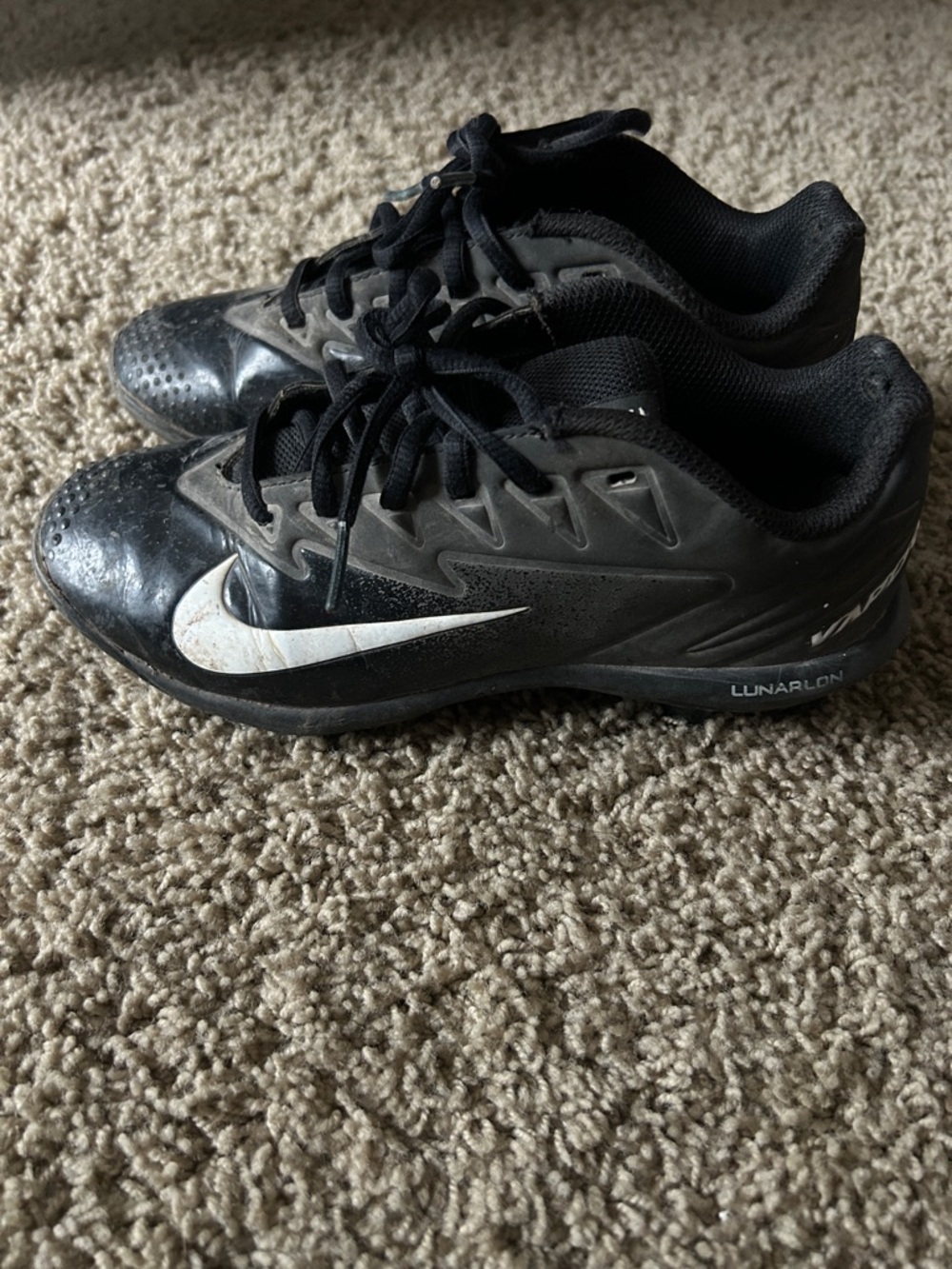 Kids Nike Black Athletic Cleats with White Swoosh